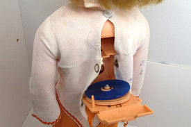 Back hatch of the doll with the small record on the phonograph.
