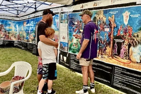 Community members inspect the Bible Panel.