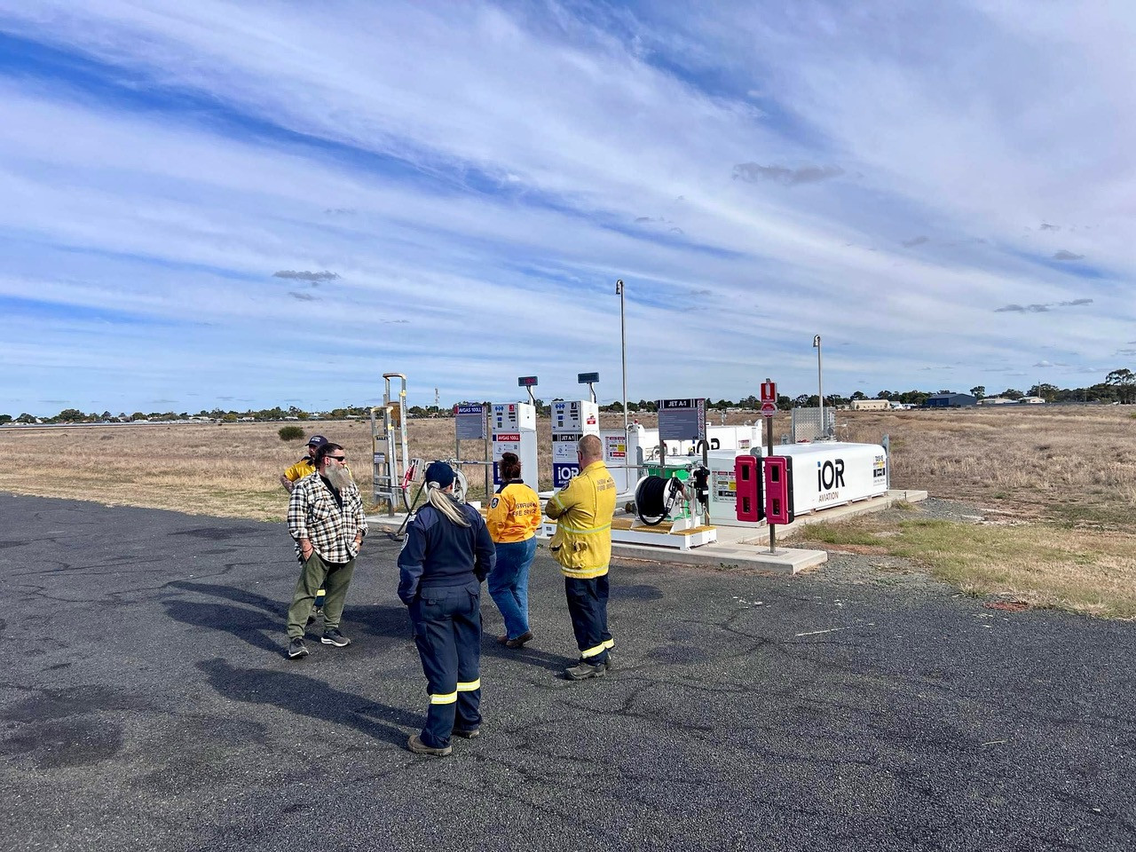 Mark Jenkins from the Bogan Shire Council shows Rural Fire Service volunteers the re-fuelling facilities at Nyngan airport.