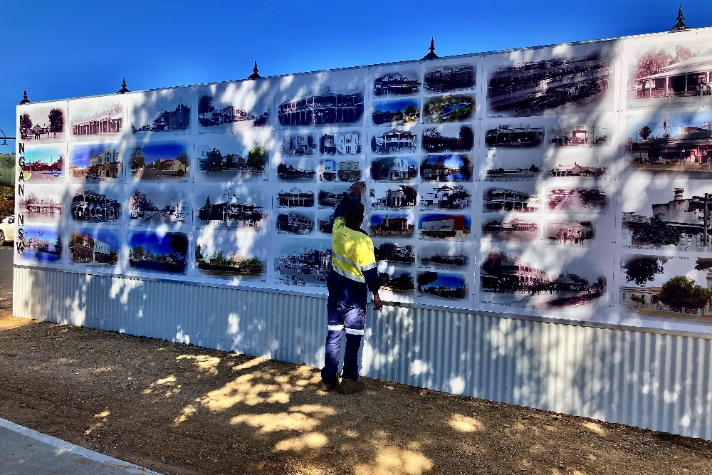 Bogan Shire Council engineer Des McGuinness puts the final touches to the new mural wall. Photo: Supplied.