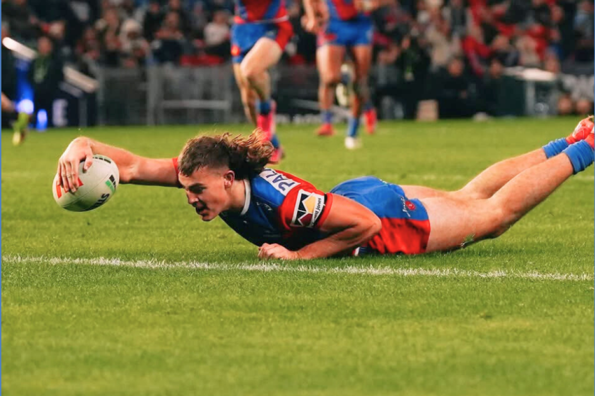 Fletcher Hunt about to put the ball down to score his first NRL try.