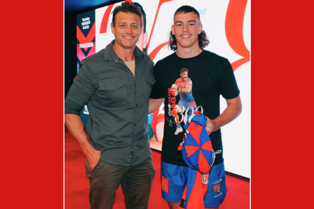 Erin and Danny Hunt with their son Fletcher and the jersey he wore in his National Rugby League debut. Photo: Newcastle Knights.