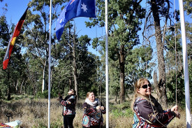 Raylene Weldon, Veneta Dutton and Marea Johnson raising the flags.